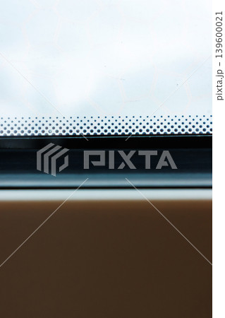 Train window with shallow depth of field, with raindrops on the glass and a foggy view outside and subtle motion blur. Minimal travel detail with atmospheric mood. Copy space Train window with shallow depth of field, with raindrops on the glass and a foggy view outside and subtle motion blur. Minimal travel detail with atmospheric mood. Copy space 139600021