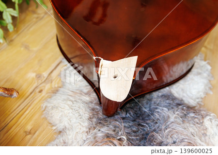 Broken contrabass neck close up. Classical string instrument repair concept Broken contrabass neck close up. Classical string instrument repair concept 139600025