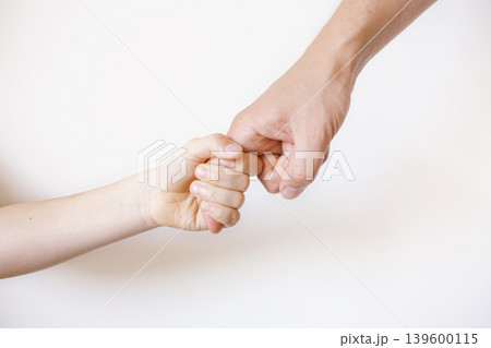 Child holds dad's finger. White background Child holds dad's finger. White background 139600115