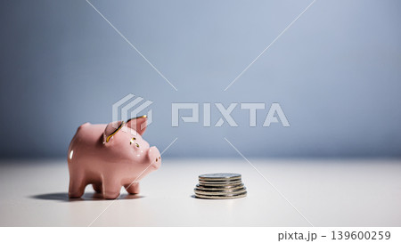 Pink piggy bank with coins Pink piggy bank with coins 139600259