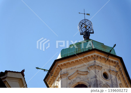 Astronomical Tower of the Klementinum in Prague with Atlant statue holding heavens, Czech Republic, clear blue sky, sunny day Astronomical Tower of the Klementinum in Prague with Atlant statue holding heavens, Czech Republic, clear blue sky, sunny day 139600272
