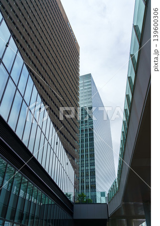 Tokyo, Japan - Oct 01 2024, vertical view of glass skyscraper facades against a cloudy sky in the Chiyoda district, at daytime, Tokyo, Japan Tokyo, Japan - Oct 01 2024, vertical view of glass skyscraper facades against a cloudy sky in the Chiyoda district, at daytime, Tokyo, Japan 139600306