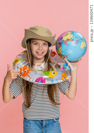 Child girl kid with inflatable ring looking at world map planning holiday trip with excitement 139600471