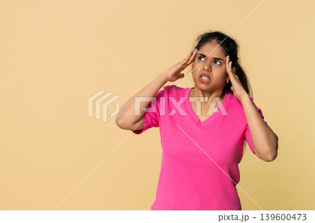 Indian woman touching temples, visibly distressed experiencing headache and fatigue 139600473