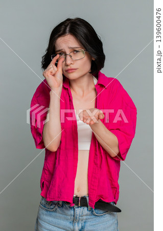 Woman holding hands together pleading with head tilted emotionally begging asking favor gesture Woman holding hands together pleading with head tilted emotionally begging asking favor gesture 139600476