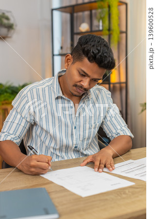 Indian man finds correct contract signs with pen smiles confident about decision result success win 139600528