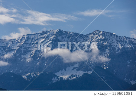 Dramatic cloud band crossing snowy Alpine mountains in Bavaria Germany 139601081