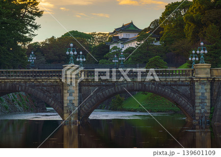 Tokyo, Japan - Oct 1 2024, A panoramic view of Nijubashi Bridge leading to main entrance of the Tokyo Imperial Palace grounds, with evening sky and colorful clouds in the background, Tokyo, Japan Tokyo, Japan - Oct 1 2024, A panoramic view of Nijubashi Bridge leading to main entrance of the Tokyo Imperial Palace grounds, with evening sky and colorful clouds in the background, Tokyo, Japan 139601109