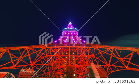 Tokyo, Japan - Oct 1 2024, panoramic view from below of the Tokyo Tower, illuminated by red light at night, with purple neon lights at the top, and a dark, clear sky, without people, Tokyo, Japan Tokyo, Japan - Oct 1 2024, panoramic view from below of the Tokyo Tower, illuminated by red light at night, with purple neon lights at the top, and a dark, clear sky, without people, Tokyo, Japan 139601263
