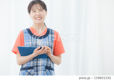 タブレットを持つエプロンの女性 139601292