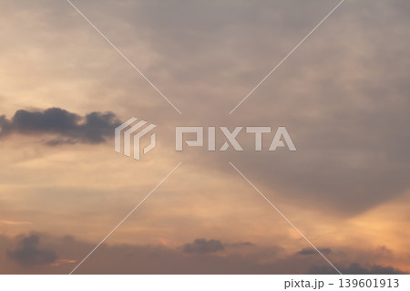 Gentle cloud formations illuminated by warm sunset light creating a calm atmospheric sky background with soft gradients and natural evening tones. Gentle cloud formations illuminated by warm sunset light creating a calm atmospheric sky background with soft gradients and natural evening tones. 139601913