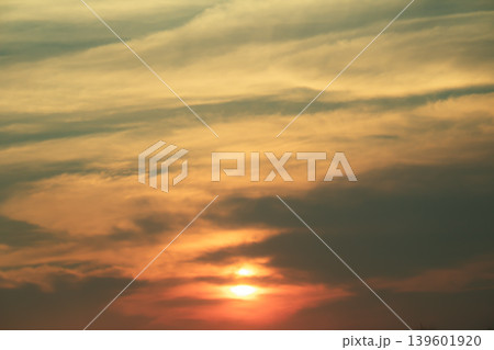 Vibrant sunset scene featuring layered clouds and glowing sunlight in warm golden tones, perfect for atmospheric backgrounds and tranquil nature themes. Vibrant sunset scene featuring layered clouds and glowing sunlight in warm golden tones, perfect for atmospheric backgrounds and tranquil nature themes. 139601920