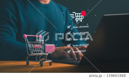 Man using laptop for online shopping and e-commerce. Digital retail business technology with shopping cart icon and order tracking via internet. Man using laptop for online shopping and e-commerce. Digital retail business technology with shopping cart icon and order tracking via internet. 139601988
