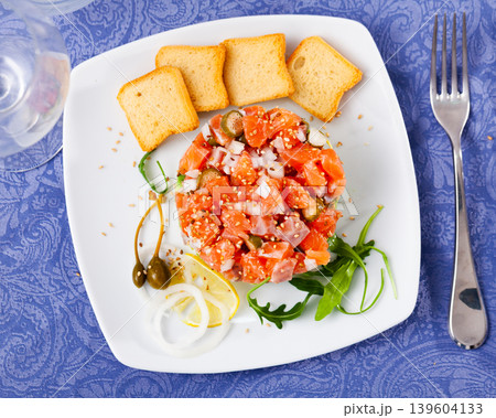 Salmon tartare with avocado served on plate 139604133
