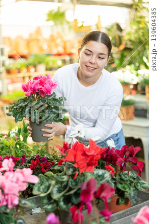 Woman buying cyclamen at flower shop 139604385