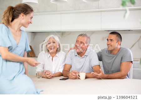Married couple and senior parents talk about home life 139604521