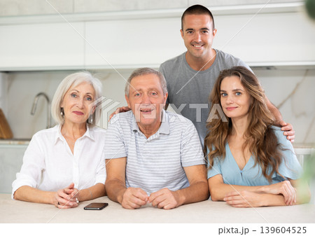 Family of four sitting in kitchen Family of four sitting in kitchen 139604525