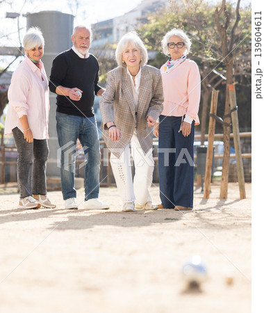 Mature people playing petanca outdoors Mature people playing petanca outdoors 139604611