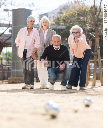 Mature people playing petanca outdoors Mature people playing petanca outdoors 139604677