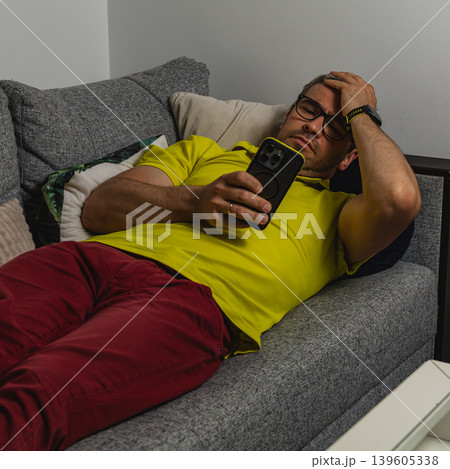 Man suffering from smartphone addiction late at night Man suffering from smartphone addiction late at night 139605338