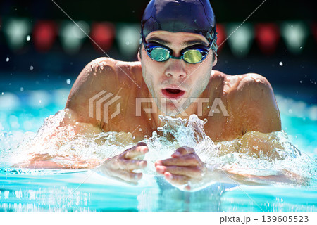 Man, swimming pool and training for sport with splash, speed and exercise for wellness, health and fitness. Swimmer, athlete or person in water for games, contest or workout with goggles in summer Man, swimming pool and training for sport with splash, speed and exercise for wellness, health and fitness. Swimmer, athlete or person in water for games, contest or workout with goggles in summer 139605523