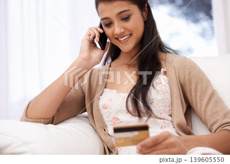 Happy woman, phone call and credit card for online shopping, payment or banking on sofa at home. Female person talking on mobile smartphone with smile for ecommerce, debit or conversation on account 139605550