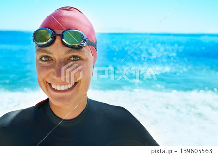 Swimmer, goggles and portrait of woman at ocean outdoor in summer for exercise, training or workout on mockup space. Sea, face or sport athlete in nature for fitness, health or triathlon at the beach 139605563