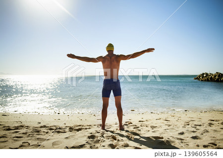 Ocean, beach and sports man for swimming exercise, nature workout or outdoor practice in water, sea or tropical island. Freedom, wellness and back of swimmer for challenge, fitness or summer cardio 139605564