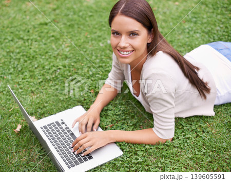 College student, portrait and woman with laptop in park on campus with research, project and education. University, person and typing on computer outdoor on lawn, grass or garden with happiness 139605591