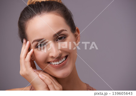 Portrait, smile and beauty with woman on space in studio for skincare, wellness or natural cosmetics. Face, aesthetic and mockup with happy young person on gray background for natural dermatology Portrait, smile and beauty with woman on space in studio for skincare, wellness or natural cosmetics. Face, aesthetic and mockup with happy young person on gray background for natural dermatology 139605643