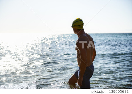 Beach, ocean water and sports man for swimming exercise, workout or training in sea, nature and looking at horizon. Physical activity, Peru and back of athlete for cardio, fitness or morning practice 139605651
