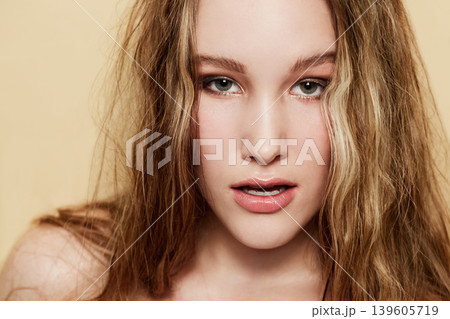 Woman, face and beauty with skin and hair, natural cosmetics with dermatology shine on beige background. Clean makeup, portrait and haircare with highlights, skincare and young model in studio Woman, face and beauty with skin and hair, natural cosmetics with dermatology shine on beige background. Clean makeup, portrait and haircare with highlights, skincare and young model in studio 139605719