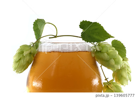 Glass of Beer with Fresh Hops and Leaves on a White Background 139605777