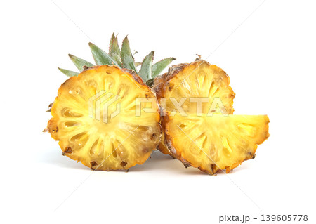 Freshly cut pineapple slices revealing juicy yellow flesh and green leaves Freshly cut pineapple slices revealing juicy yellow flesh and green leaves 139605778