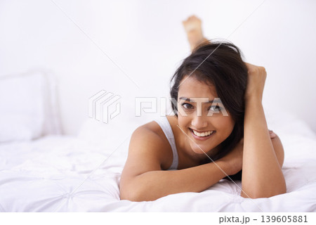 Happy woman, bed and portrait in the morning with rest and sleep in a home with a smile. Indian female person, bedroom and wake up on duvet with peace and calm in a house on a blanket with comfort Happy woman, bed and portrait in the morning with rest and sleep in a home with a smile. Indian female person, bedroom and wake up on duvet with peace and calm in a house on a blanket with comfort 139605881