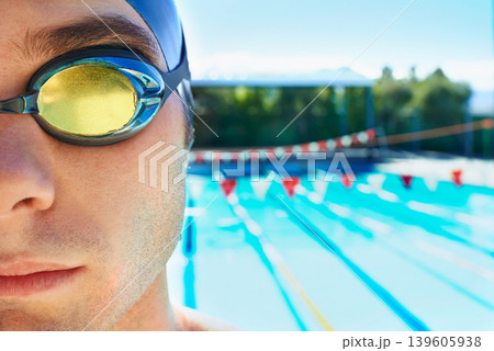 Swimming goggles, sports and portrait of man for pool exercise, outdoor workout or training practice. Commitment, poolside and face of waterpolo player for competition, fitness or cardio performance Swimming goggles, sports and portrait of man for pool exercise, outdoor workout or training practice. Commitment, poolside and face of waterpolo player for competition, fitness or cardio performance 139605938