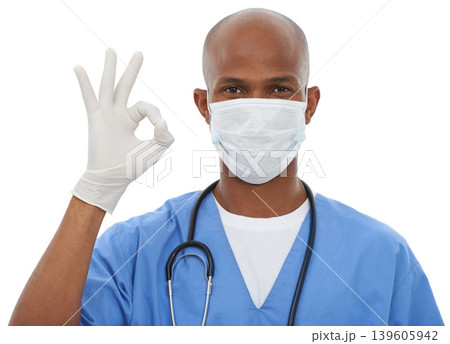 Face mask, perfect sign and portrait of doctor in a studio with glove and stethoscope for consultation. Virus, protection and African male healthcare worker with ok hand gesture by white background. 139605942
