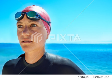 Swimmer, water and woman at ocean outdoor in summer for exercise, training or workout on mockup space. Sea, sport athlete or person in goggles in nature for fitness, health or triathlon at the beach 139605962