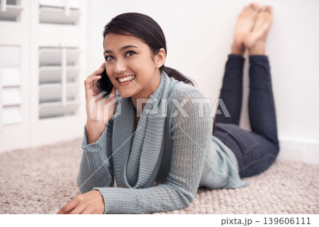 Happy woman on floor with phone call, relax and communication with mobile connection in apartment. Gen z girl lying on carpet with smile, talking on cellphone and conversation for networking in home. 139606111