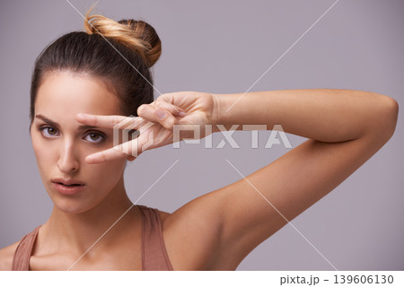 Portrait, beauty and peace sign with natural woman in studio on gray background for wellness or confidence. Face, skincare or hand gesture and serious young model with v fingers for cosmetics 139606130