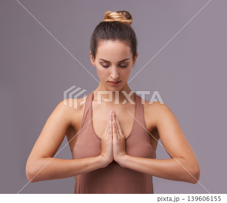 Prayer, face or woman in meditation in studio for wellness, peace or balance on purple background. Calm, relax or zen female model in yoga pose for energy, mental health or holistic breathing Prayer, face or woman in meditation in studio for wellness, peace or balance on purple background. Calm, relax or zen female model in yoga pose for energy, mental health or holistic breathing 139606155