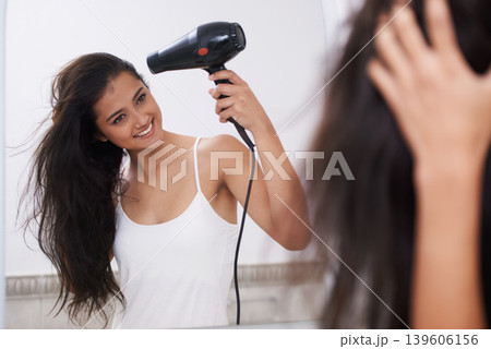 Blow dry, home and woman with hair care, happy and mirror with treatment, grooming and routine. Person, smile and girl with salon equipment, texture and volume with shine, glowing and wellness Blow dry, home and woman with hair care, happy and mirror with treatment, grooming and routine. Person, smile and girl with salon equipment, texture and volume with shine, glowing and wellness 139606156