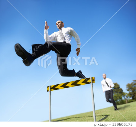 Businessman, hurdle and jumping for career competition or employee obstacle, opponent or achievement. Male people, corporate rivals and leap for professional growth or challenge, milestone or mockup Businessman, hurdle and jumping for career competition or employee obstacle, opponent or achievement. Male people, corporate rivals and leap for professional growth or challenge, milestone or mockup 139606173