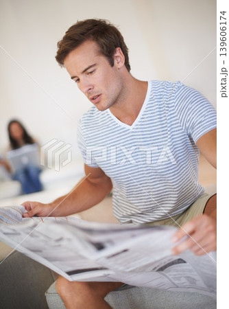 Man, reading and newspaper for morning information at home for global events, knowledge or politics. Male person, couch and print media discussion or worldwide crisis problem, international or report 139606174