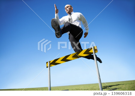 Businessman, hurdle and jumping for career obstacle or competition or employee challenge, growth or achievement. Male person, leap and work professional goals for overcome, job development or mockup Businessman, hurdle and jumping for career obstacle or competition or employee challenge, growth or achievement. Male person, leap and work professional goals for overcome, job development or mockup 139606318