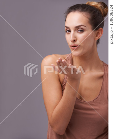 Portrait of woman, blow kiss or skincare with beauty or cosmetics for healthy glow or results. Isolated, flirting or confident model with natural shine or wellness in studio on purple background Portrait of woman, blow kiss or skincare with beauty or cosmetics for healthy glow or results. Isolated, flirting or confident model with natural shine or wellness in studio on purple background 139606324