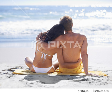 Relax, hug and couple on beach for holiday adventure together on tropical island with towel from back. Love, man and woman on ocean vacation with embrace, romance and calm nature on travel in Hawaii. 139606480