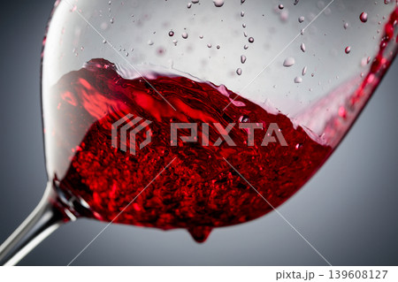 Red wine is poured into a glass. Red wine is poured into a glass. 139608127