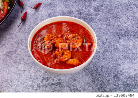 Spicy shrimp soup Red Thai Curry with prawns and vegetables in a vibrant red broth. Asian cuisine concept. Spicy shrimp soup Red Thai Curry with prawns and vegetables in a vibrant red broth. Asian cuisine concept. 139608494