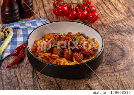 Pasta with meatballs, cherry tomatoes, and chili peppers on a wooden table, vibrant food photography Pasta with meatballs, cherry tomatoes, and chili peppers on a wooden table, vibrant food photography 139608536